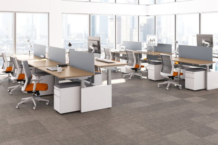Height adjustable desks with white base and wood top