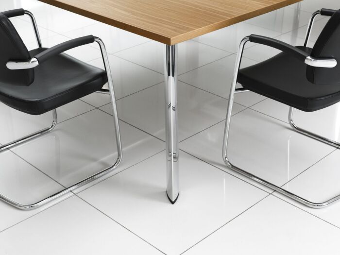 modern conference table with chrome legs and black chairs