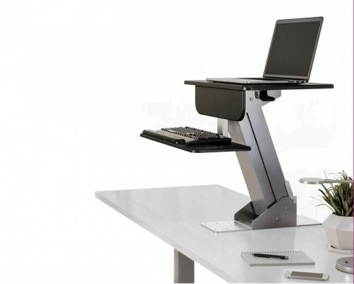 ESI Lift Sit To Stand height adjustable workstation mounted to a white desk