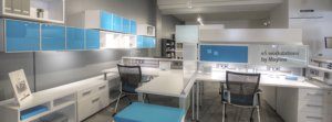 An open concept example of workplace design white workstations with bold blue accents