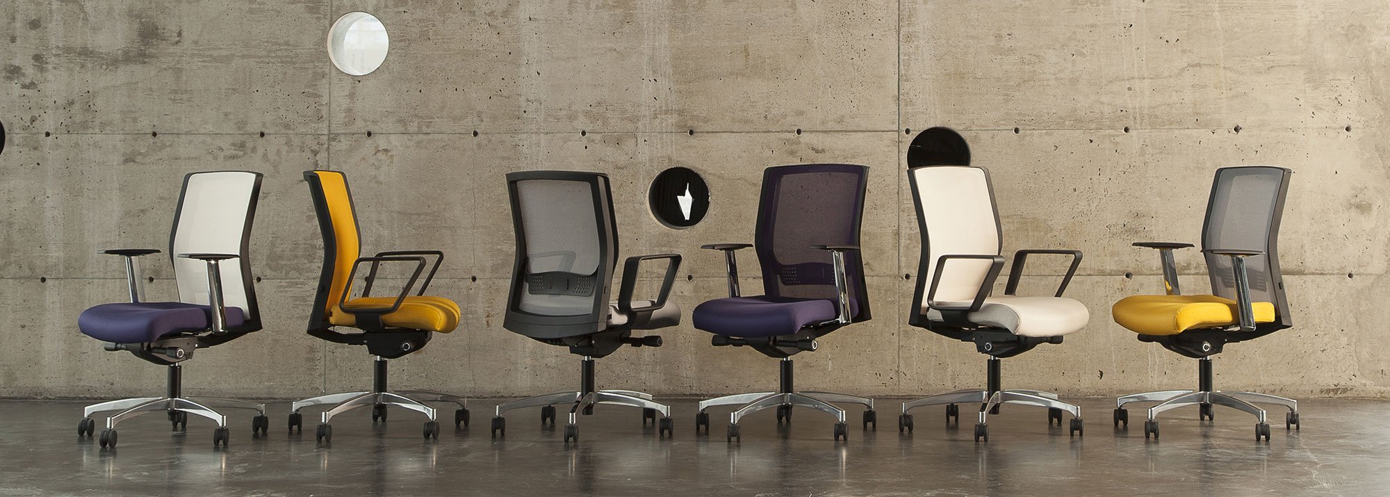 modern desk chairs lined up in an concrete industrial location