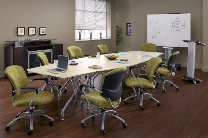 Studio photograph of six 5331-2 model Supra chairs placed at a long onference table. In front is a podium and white board.
