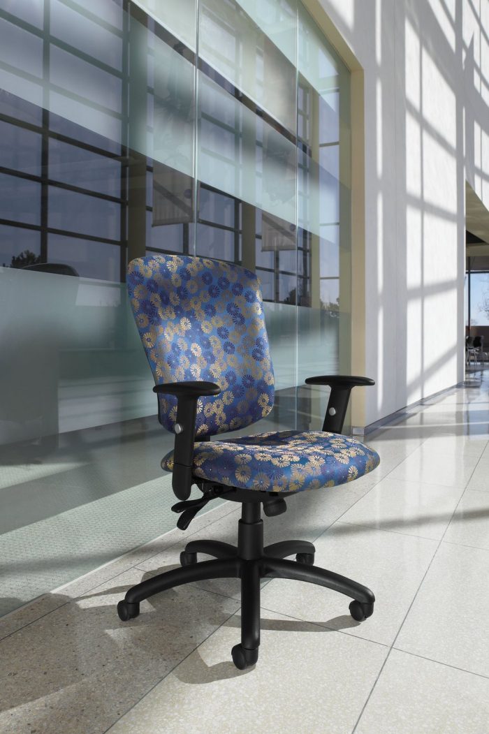 Studio shot a high backed Supra office chairs. The seat and back cushions have a blue and gold floral pattern.