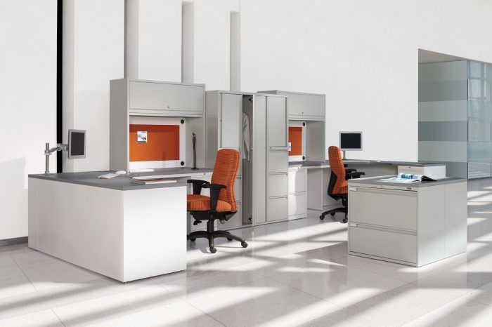 Studio Shot of Two large reception desks and cubicles, with a Synopsis chair placed at each. Behind it are some tall cabinets.