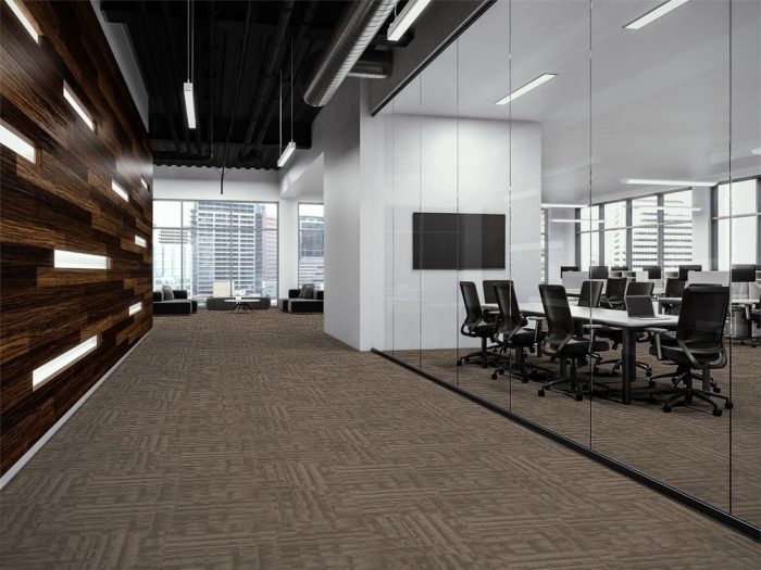 Outfitter carpet along a company corridor. There is glass walls to the left, looking into a large meeting space. At the end is guest seating looking out to the city.