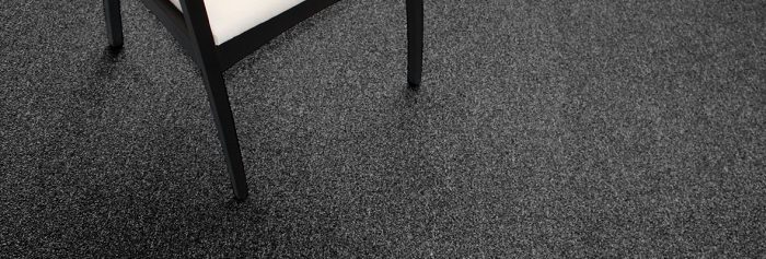 Studio shot of a black legged chair resting on Passages carpeting.
