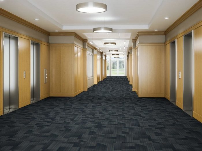 Looking down a hallway, leading to the elevator banks in a commercial building. The floor is lined in Skyline model carpeting.
