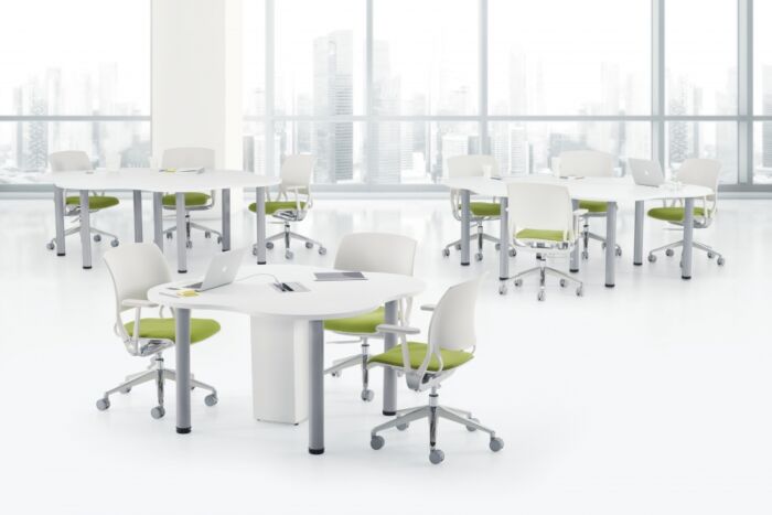 white square training tables with green cushioned seating